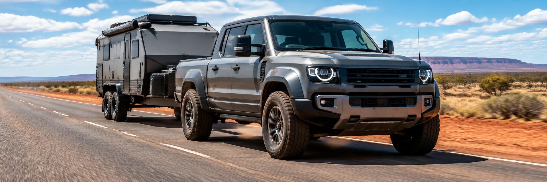 Grey NEW Defender UTE concept towing an off-road camper trailer on an outback highway – www.defender-accessories.com
