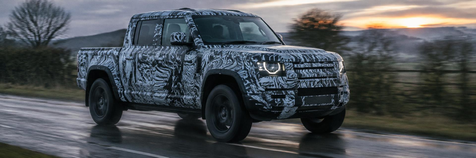 Editorial illustration of a camouflaged dual-cab Defender UTE prototype on a test road for www.defender-accessories.com
